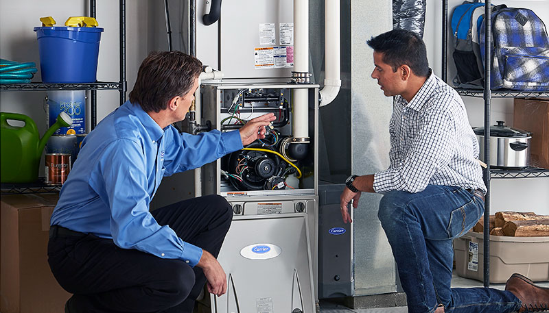 HVAC technician evaluating a furnace for repair or replacement in West Jordan