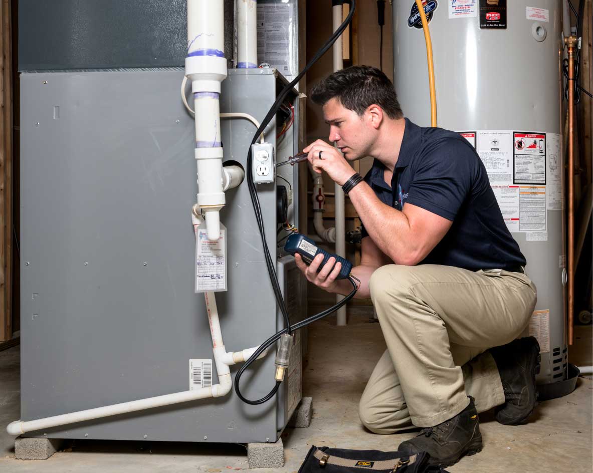 HVAC technician performing a furnace tune-up in West Jordan