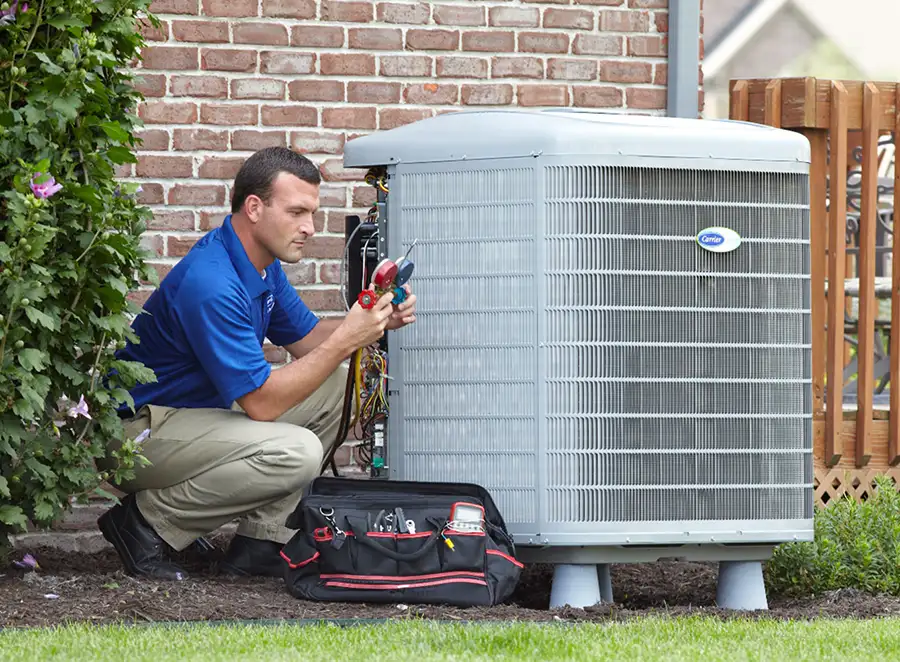 HVAC technician inspecting an outdoor air conditioning unit in West Jordan