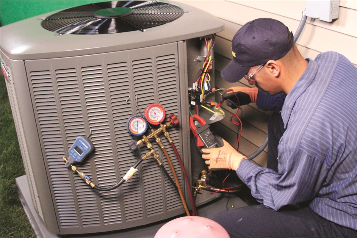 HVAC technician testing an outdoor air conditioning unit in West Jordan