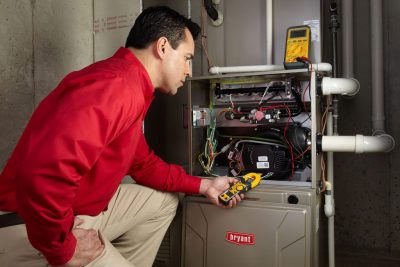 furnace repair Heating and air conditioning technician servicing an indoor furnace in West Jordan, UT